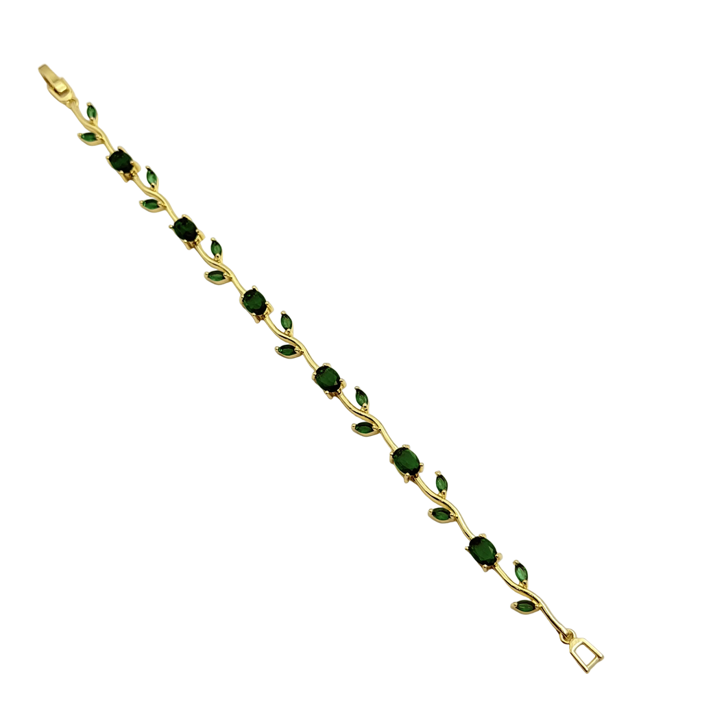 Gold bracelet with green gemstones on a white background