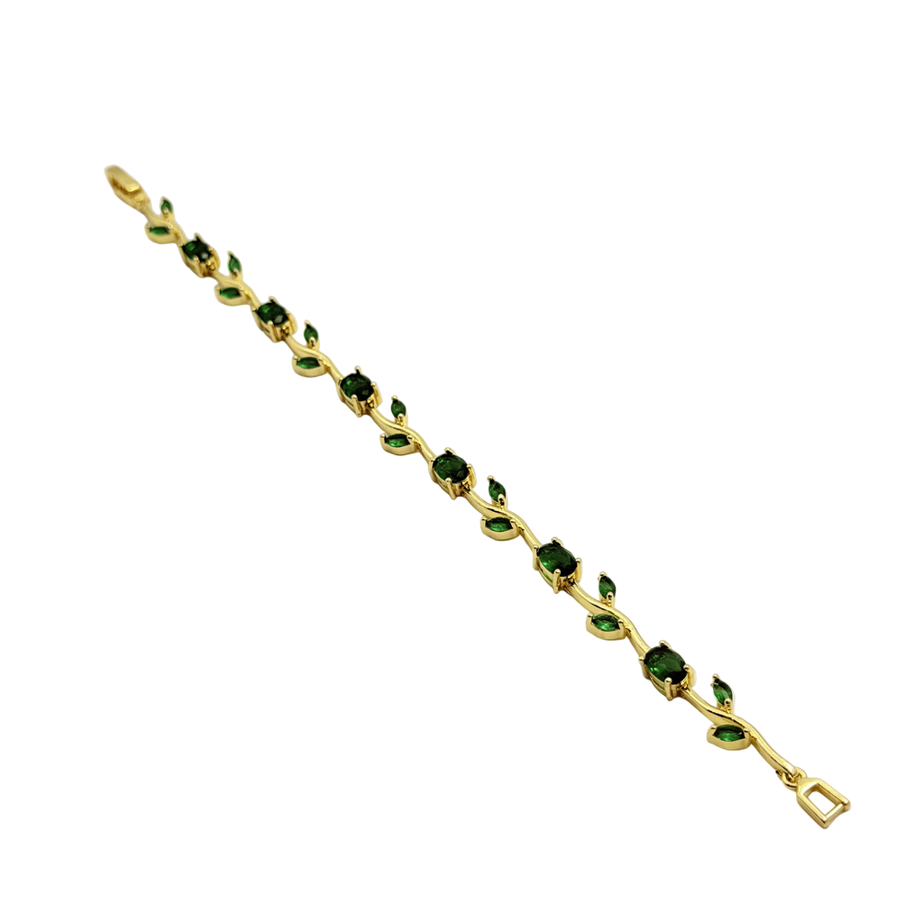 Gold bracelet with green gemstones on a white background