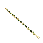 Gold bracelet with green gemstones on a white background