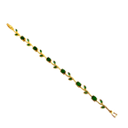 Gold bracelet with green gemstones on a black background