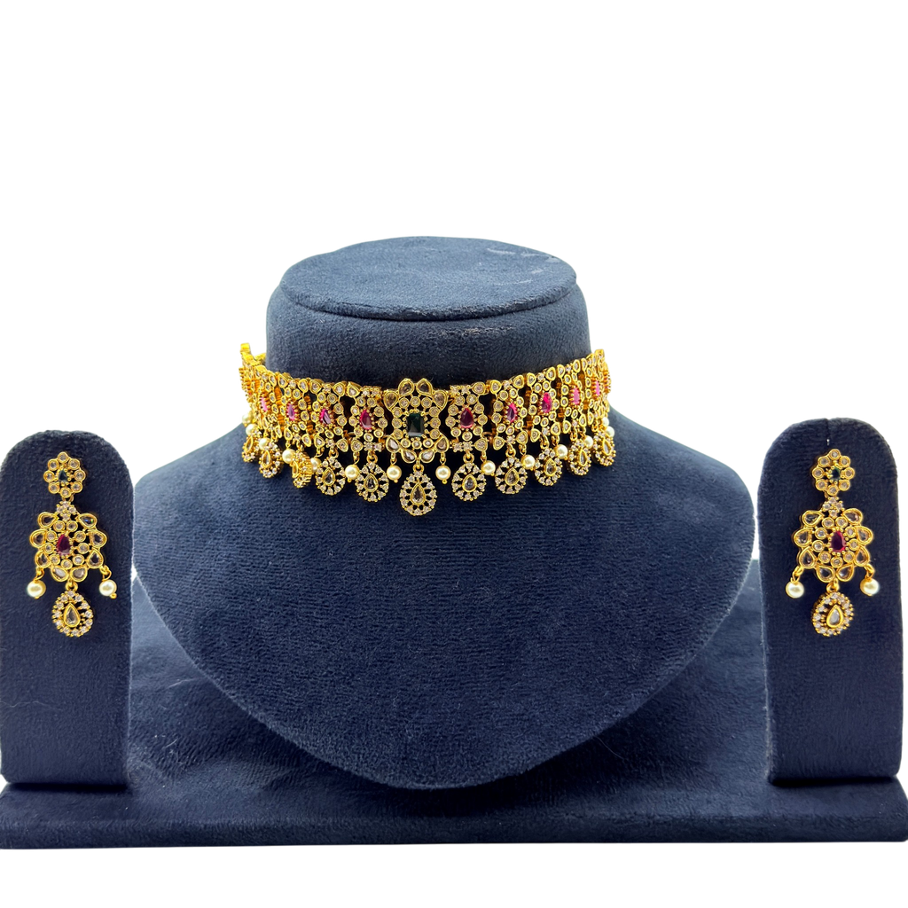 Gold vintage floral choker necklace and drop earrings with ruby and emerald stones, front flat-lay display