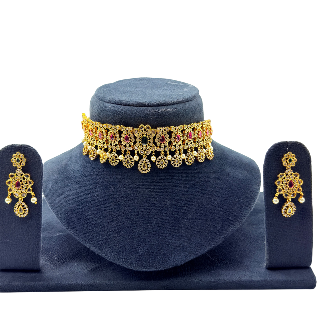 Gold vintage floral choker necklace and drop earrings with ruby and emerald stones, front flat-lay display