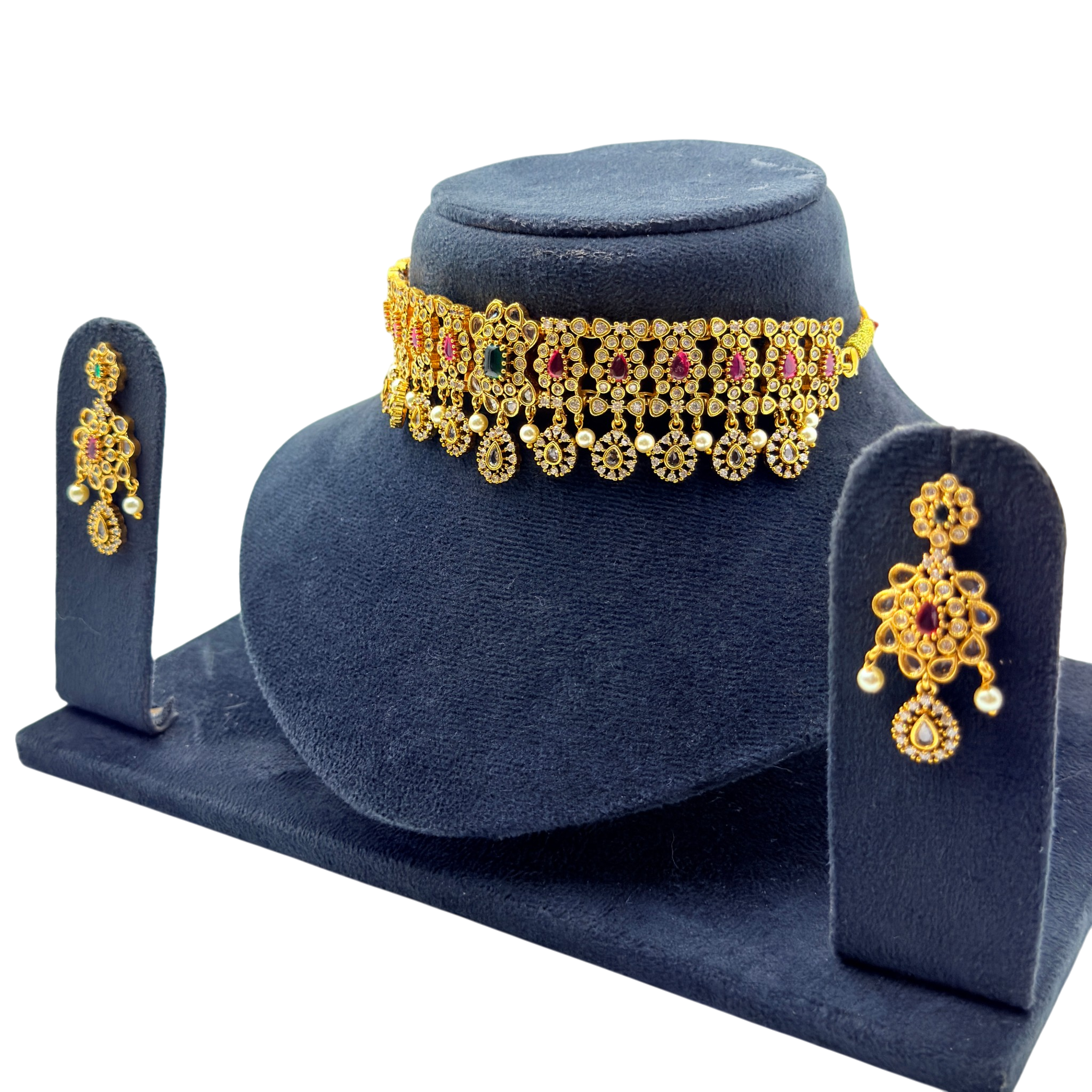 Gold necklace and earrings set on a blue stand with a white background