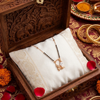 Decorative wooden jewelry box with a necklace on a patterned fabric background