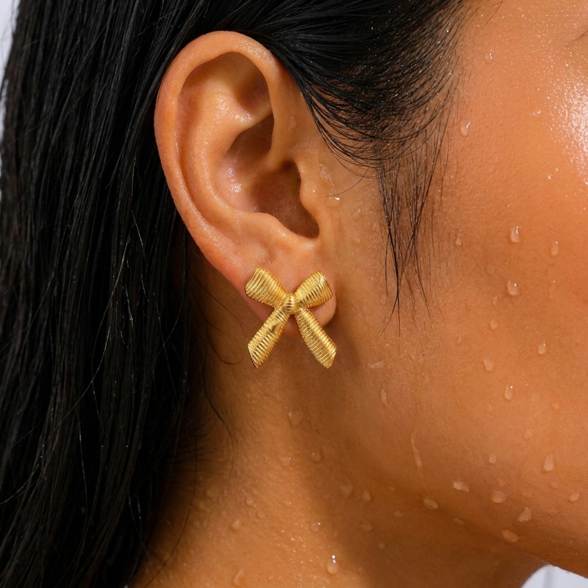 KJ-AI-GALLERY-v1 | Textured Ribbon Bow Earrings — worn close-up editorial | Krystal Jewels
