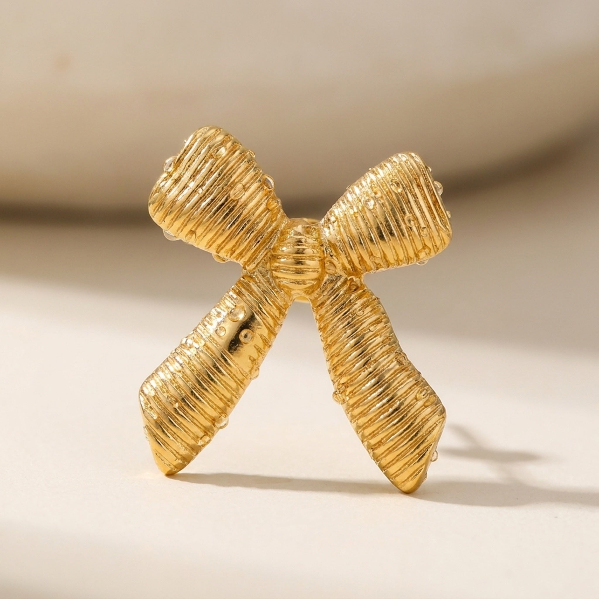 KJ-AI-GALLERY-v1 | Textured Ribbon Bow Earrings — macro detail | Krystal Jewels