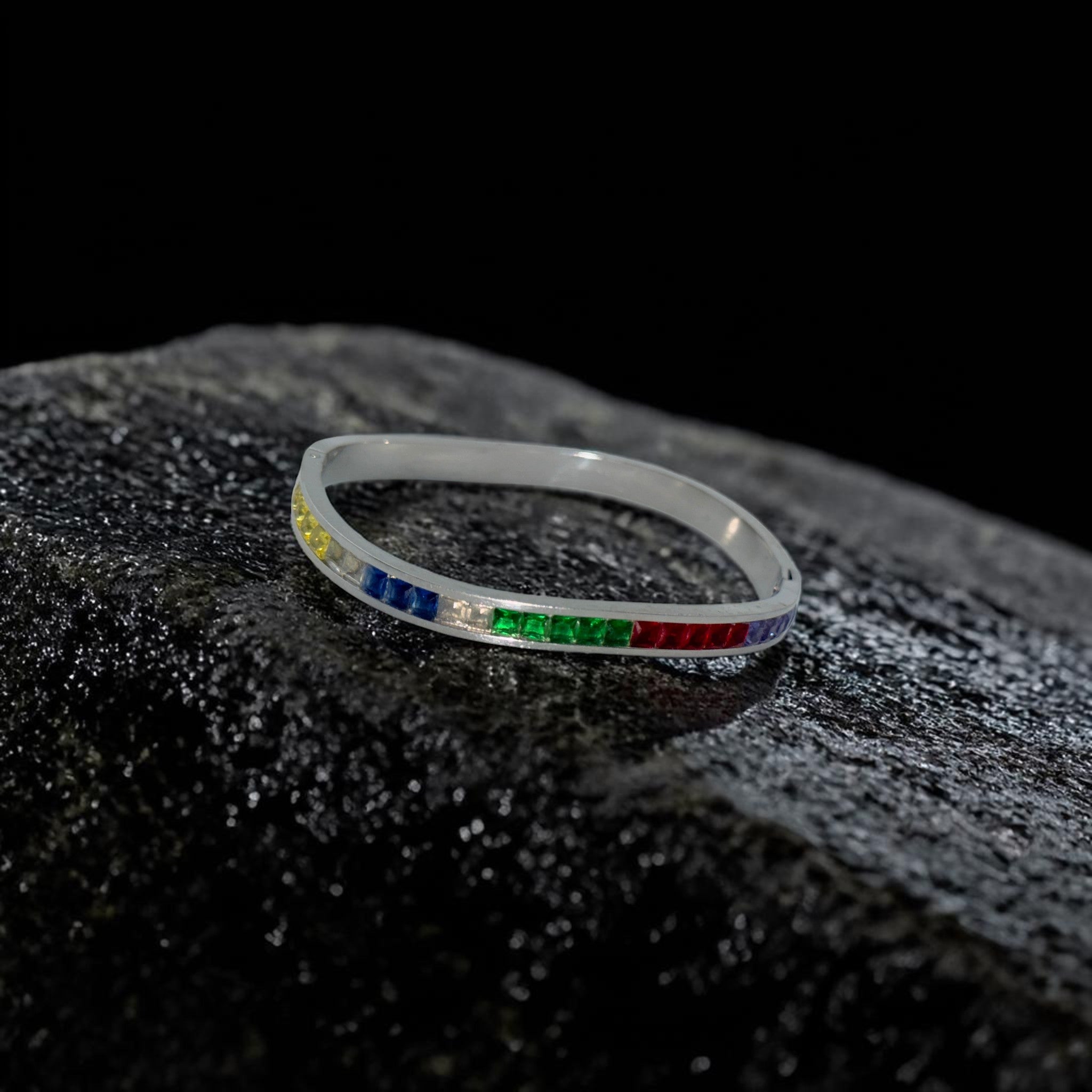 Bracelet with colorful gemstones on a textured black surface