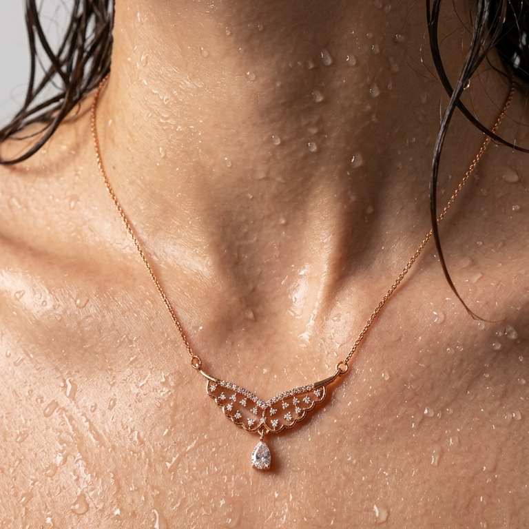 Necklace with a pendant on a person's neck with water droplets on skin